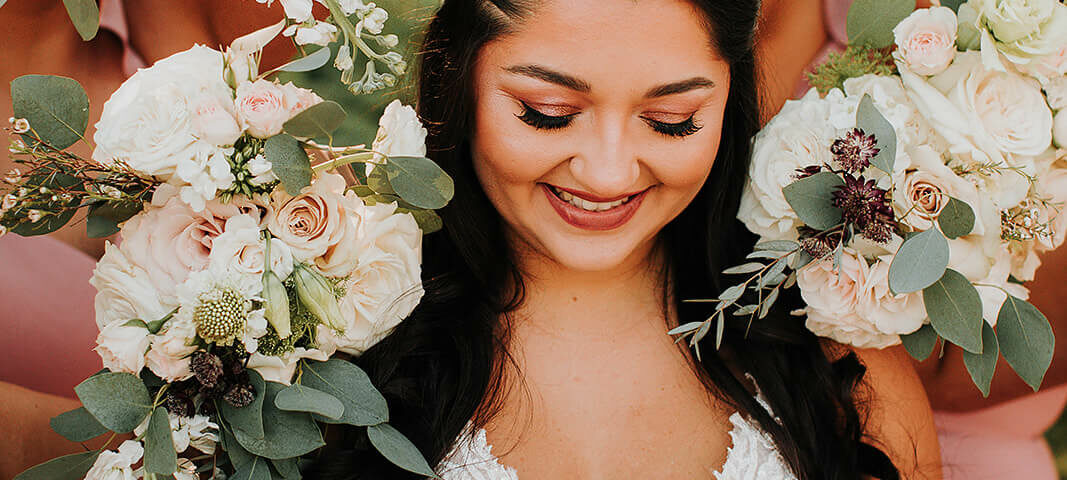 Bride Holding Bouquet Surrounded By Flowers