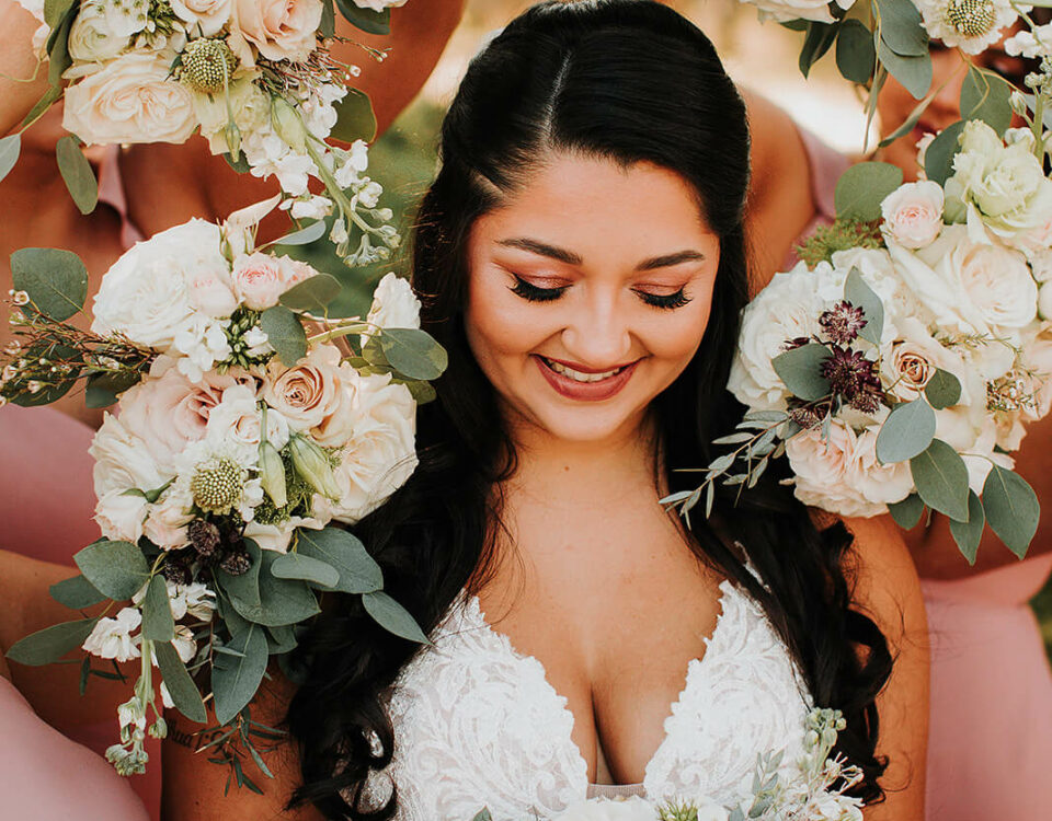 Bride Holding Bouquet Surrounded By Flowers