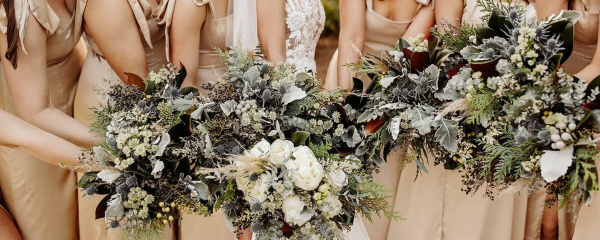 Bride and Bridesmaids Holding White and Blue Bouquets