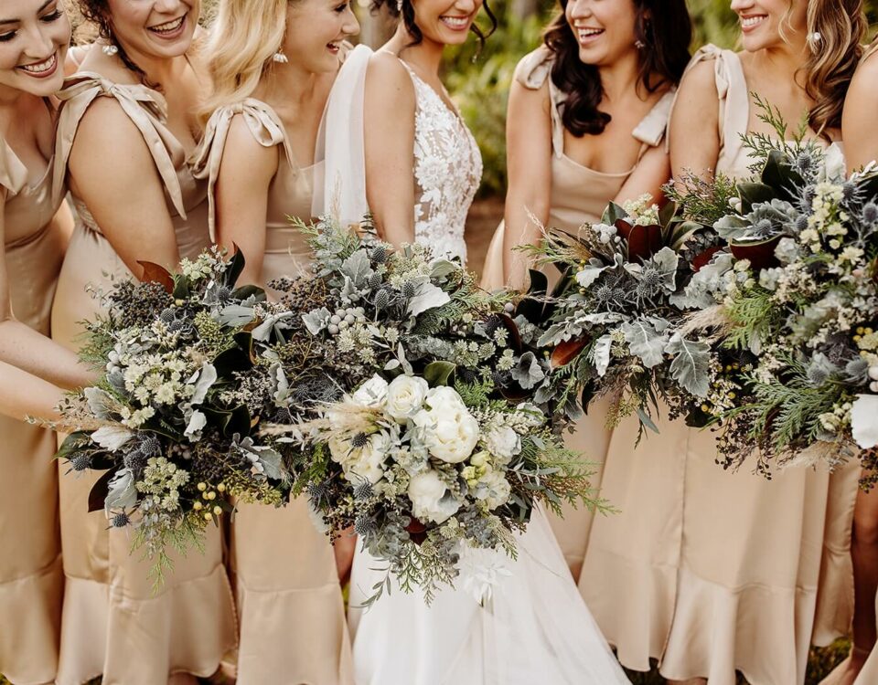 Bride and Bridesmaids Holding White and Blue Bouquets